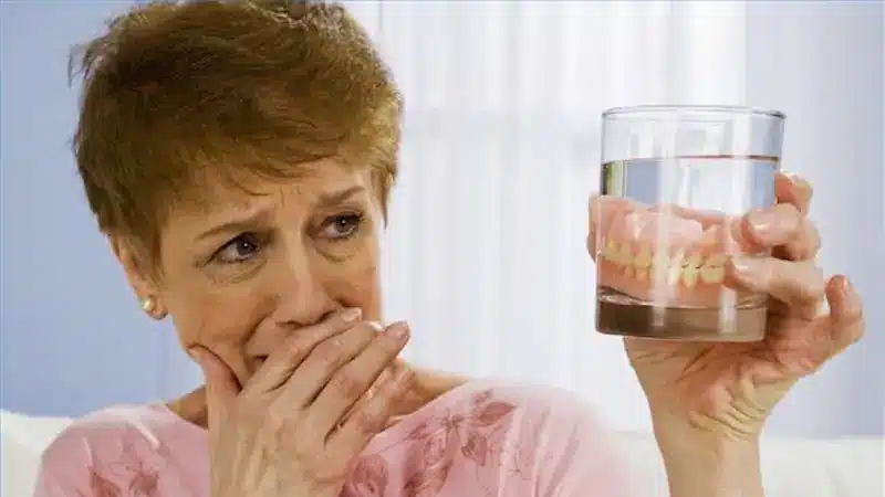 Woman looking at her dentures