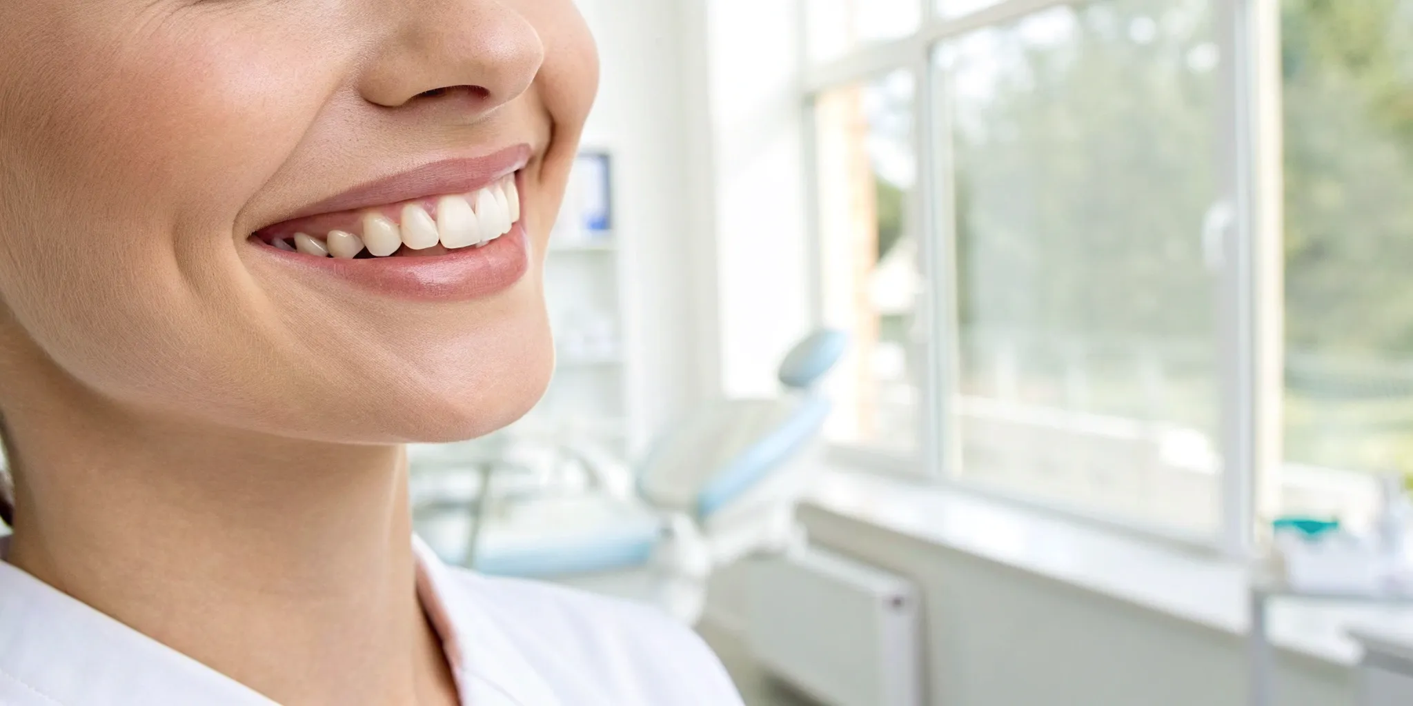 A woman smiling, happy with the cost and results of her All-on-4 teeth in a day treatment.