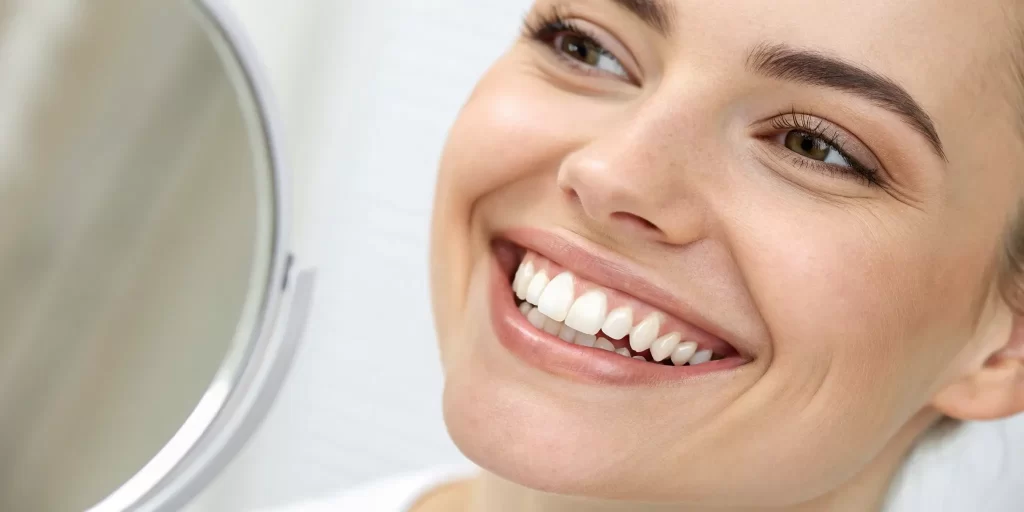 Before and after pictures of a beautiful smile transformed by natural-looking dentures.